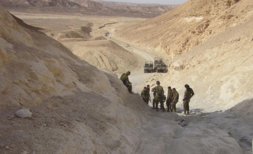 Soldiers practicing driving up and down a steep difficult incline
