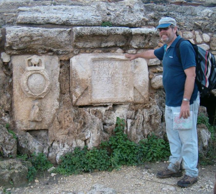 Don standing next to two tablets on the Caesarea Roman aqueduct.