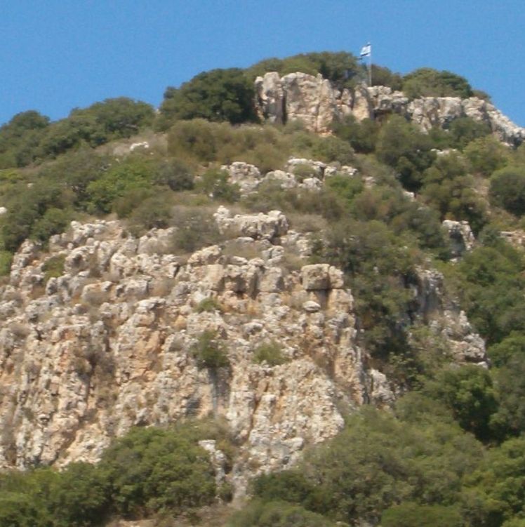 cliffs with an Israeli flag flying in the wind at the top.