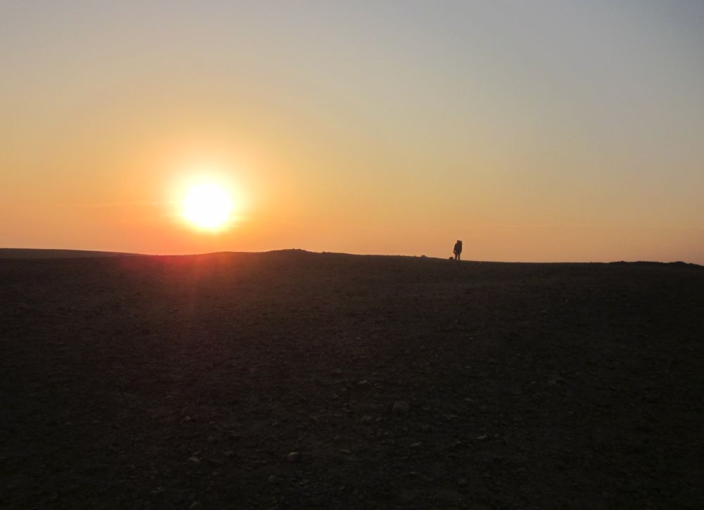 Don silhouetted by the rising sun on the Cracks plateau.