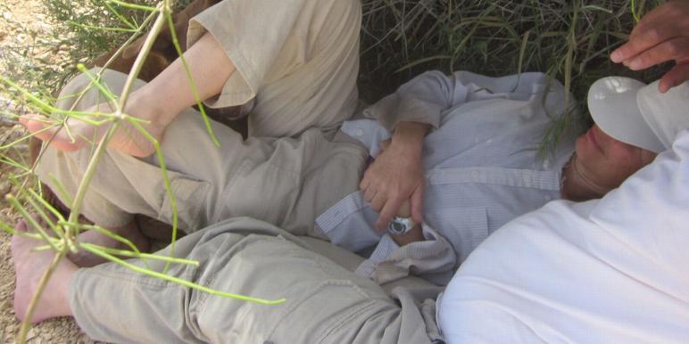 Don and Diana resting in the shade of a low bush