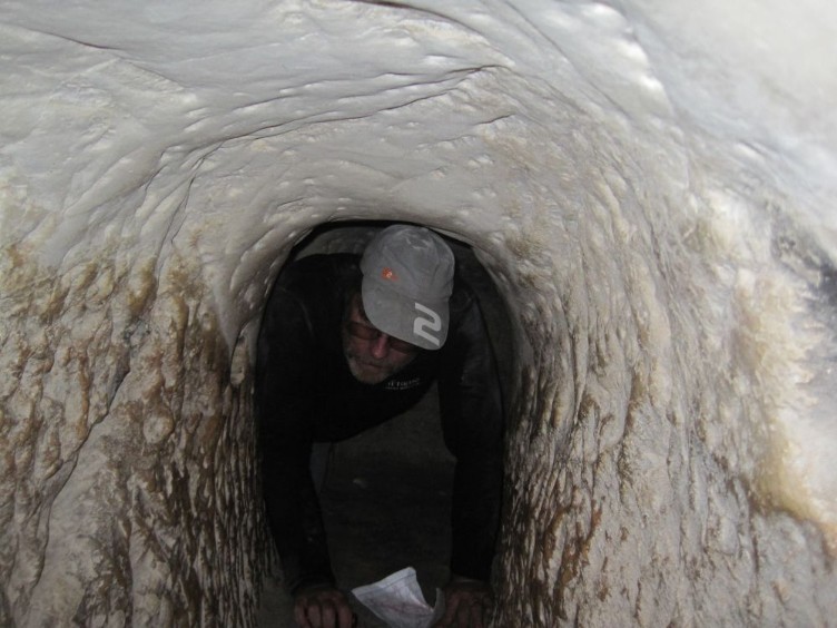 Don crawling in Bar Kochba era tunnel leading to secret meeting room