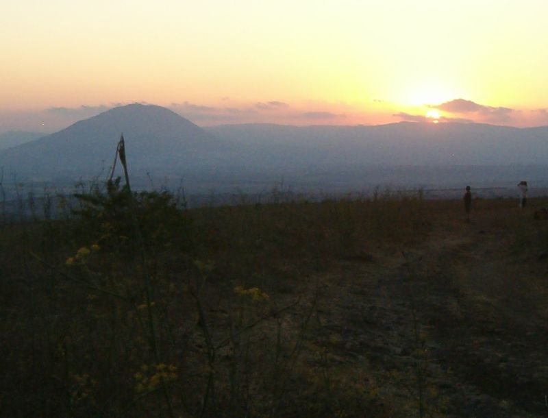 Two young men praying the evening prayers - Mount Tabor in the background